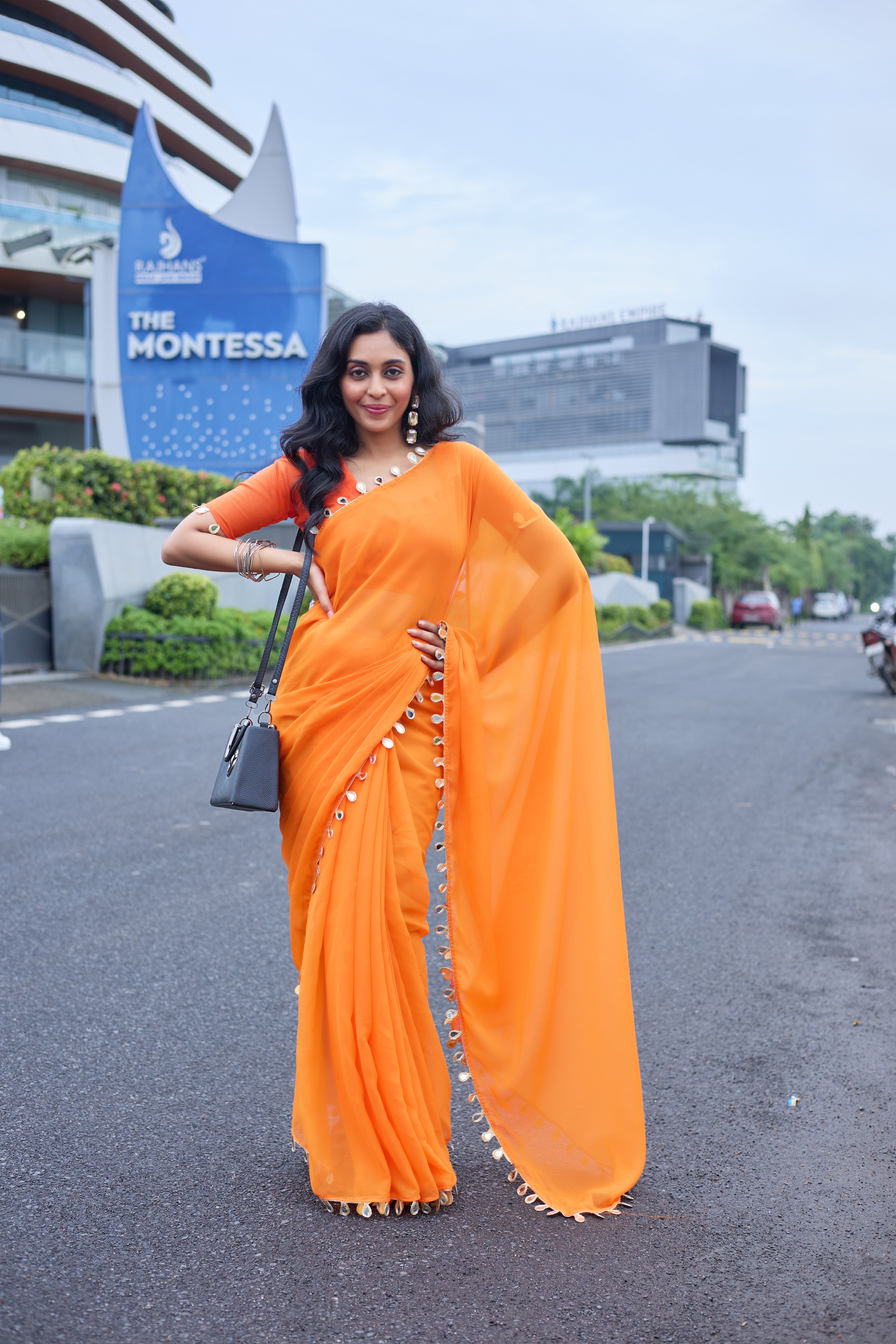 Sunset Glow Orange Saree with Shell Embellishments