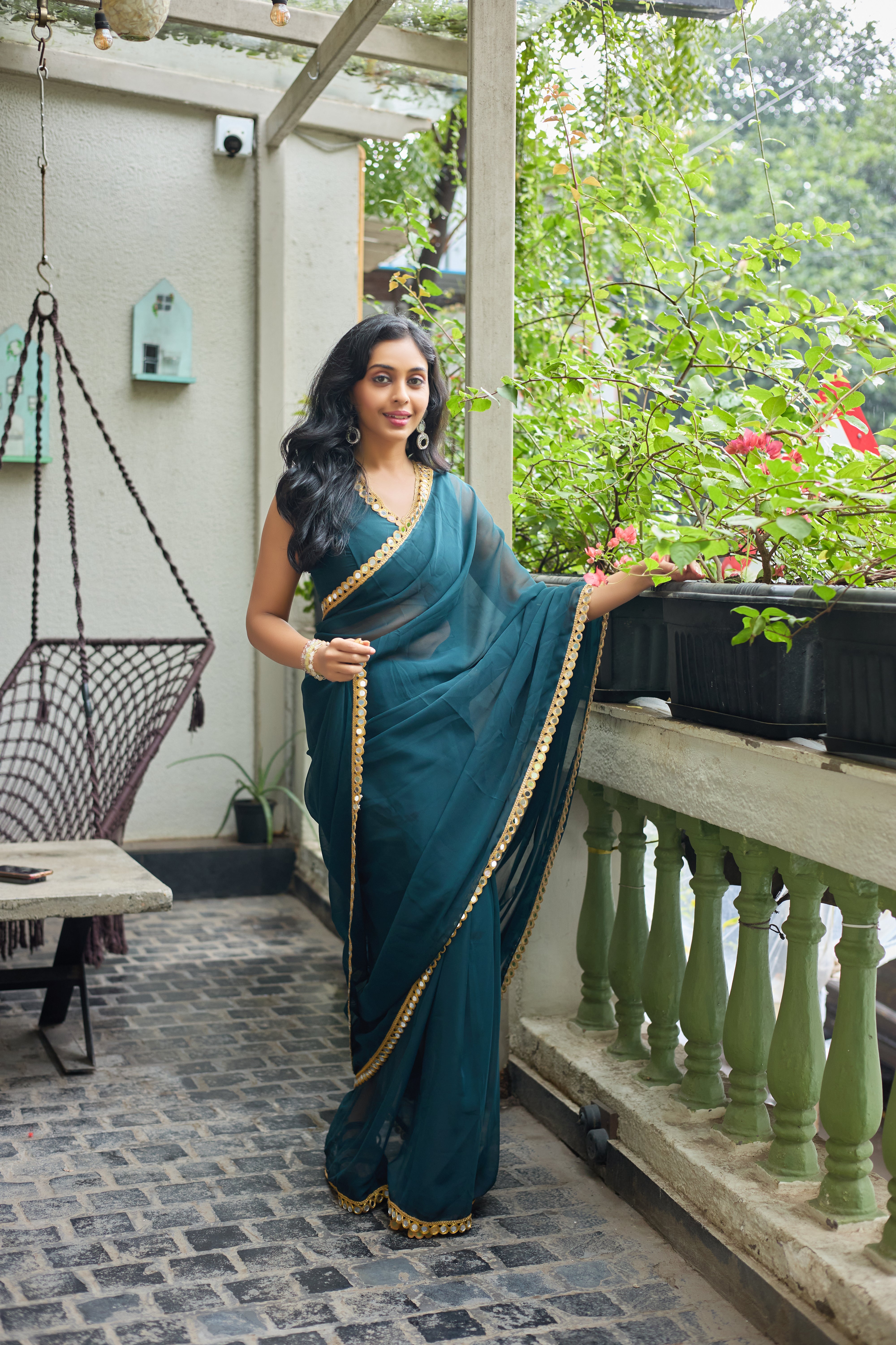Teal Charm Georgette Saree with Golden Mirror Work Border