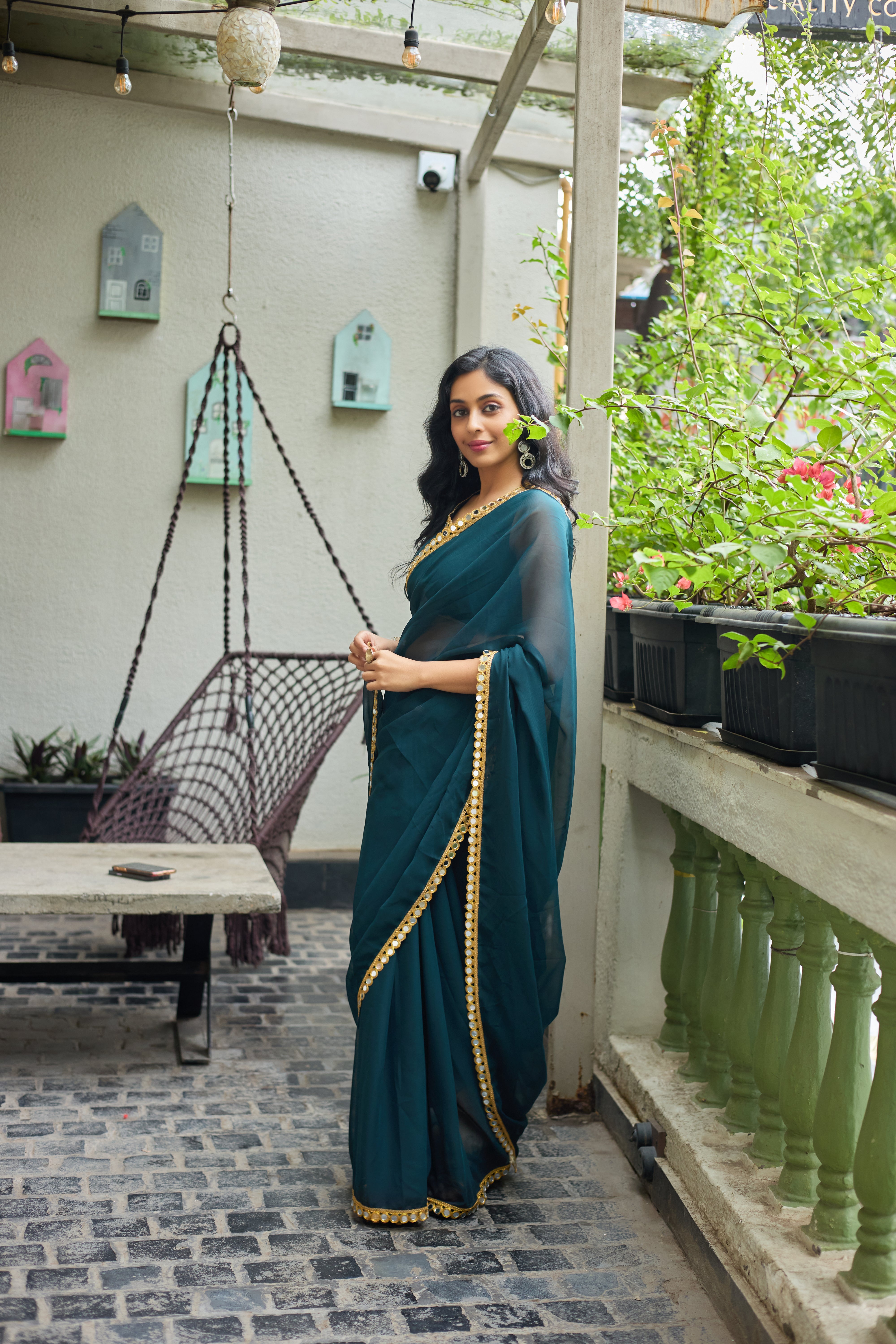 Teal Charm Georgette Saree with Golden Mirror Work Border