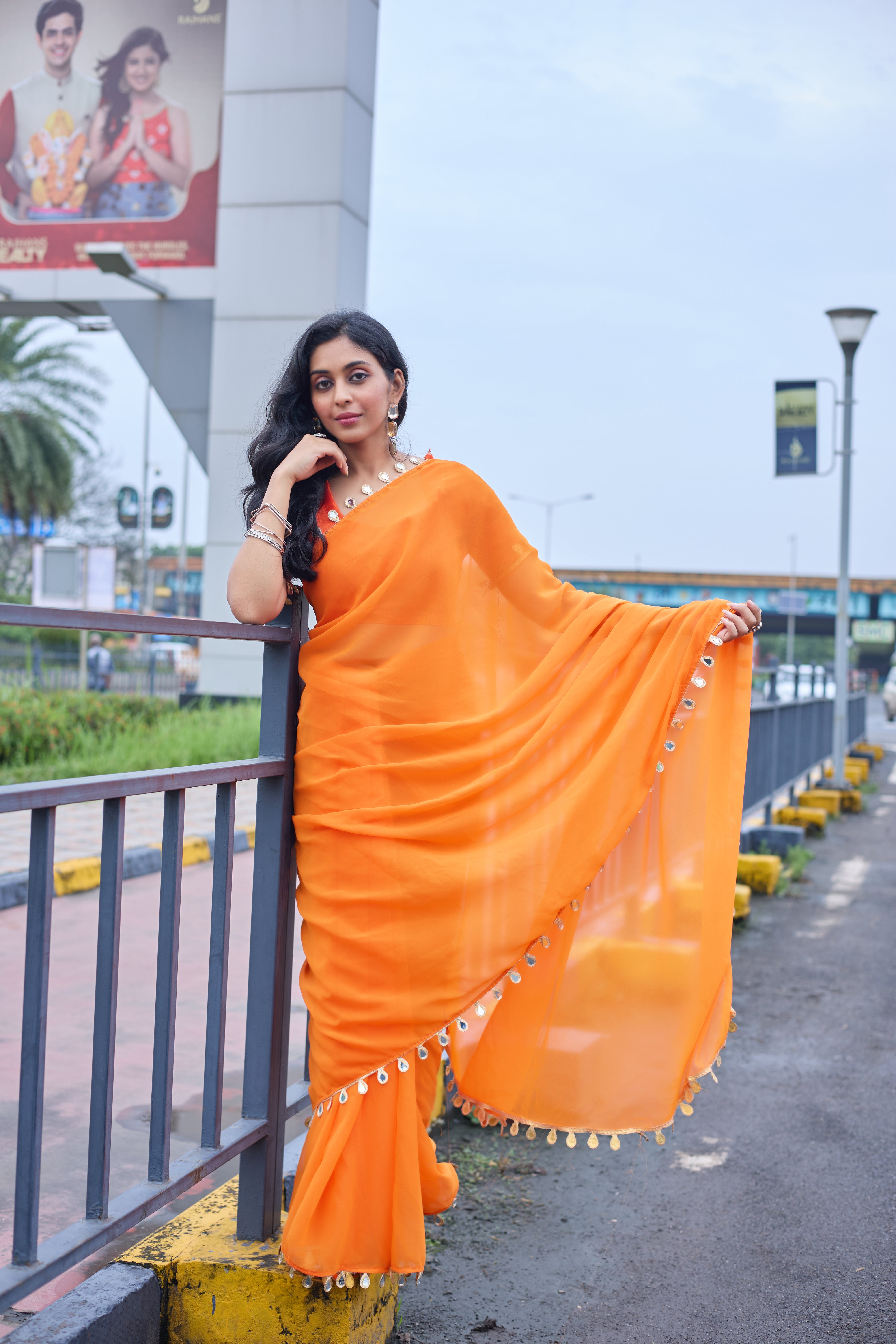Sunset Glow Orange Saree with Shell Embellishments