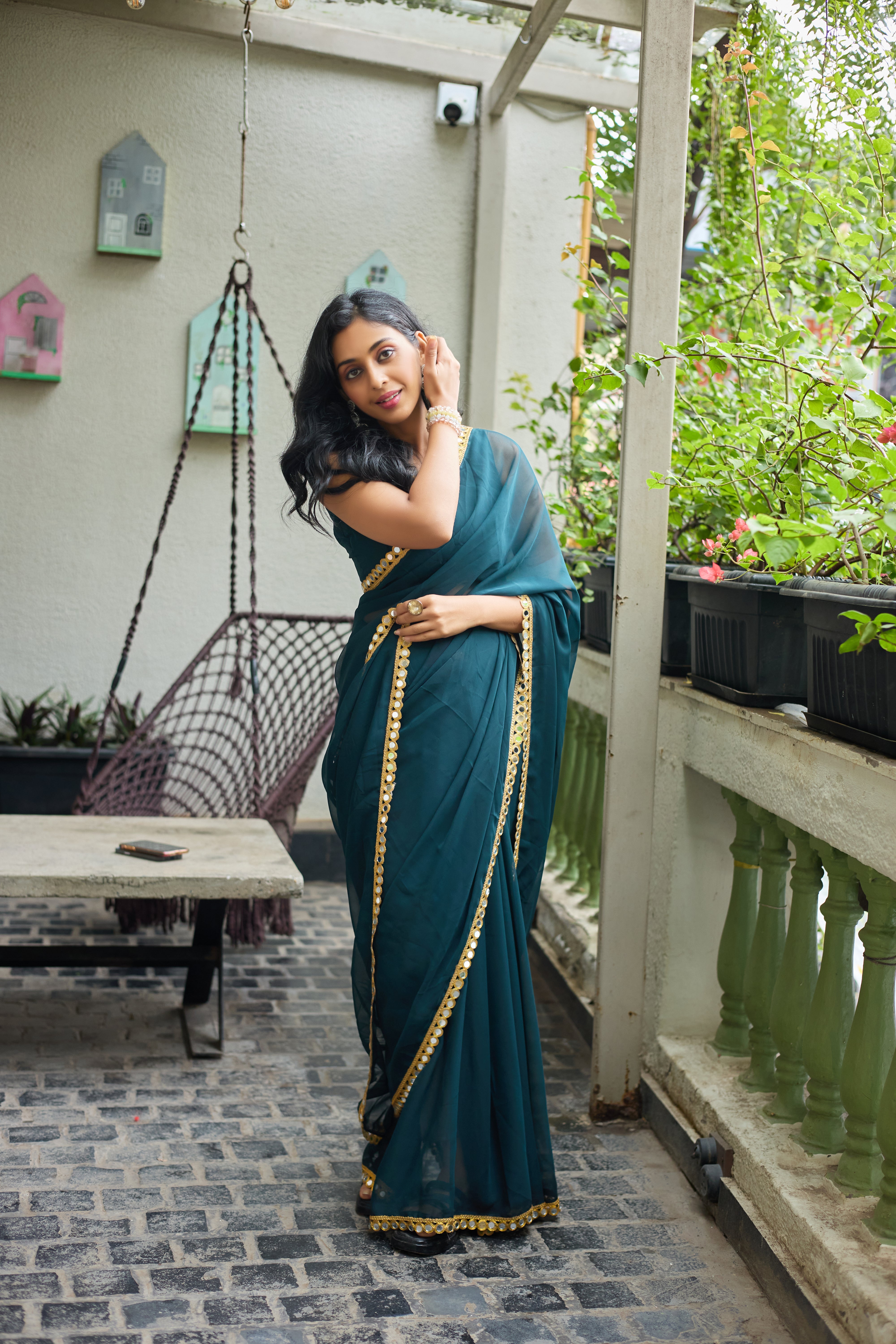 Teal Charm Georgette Saree with Golden Mirror Work Border