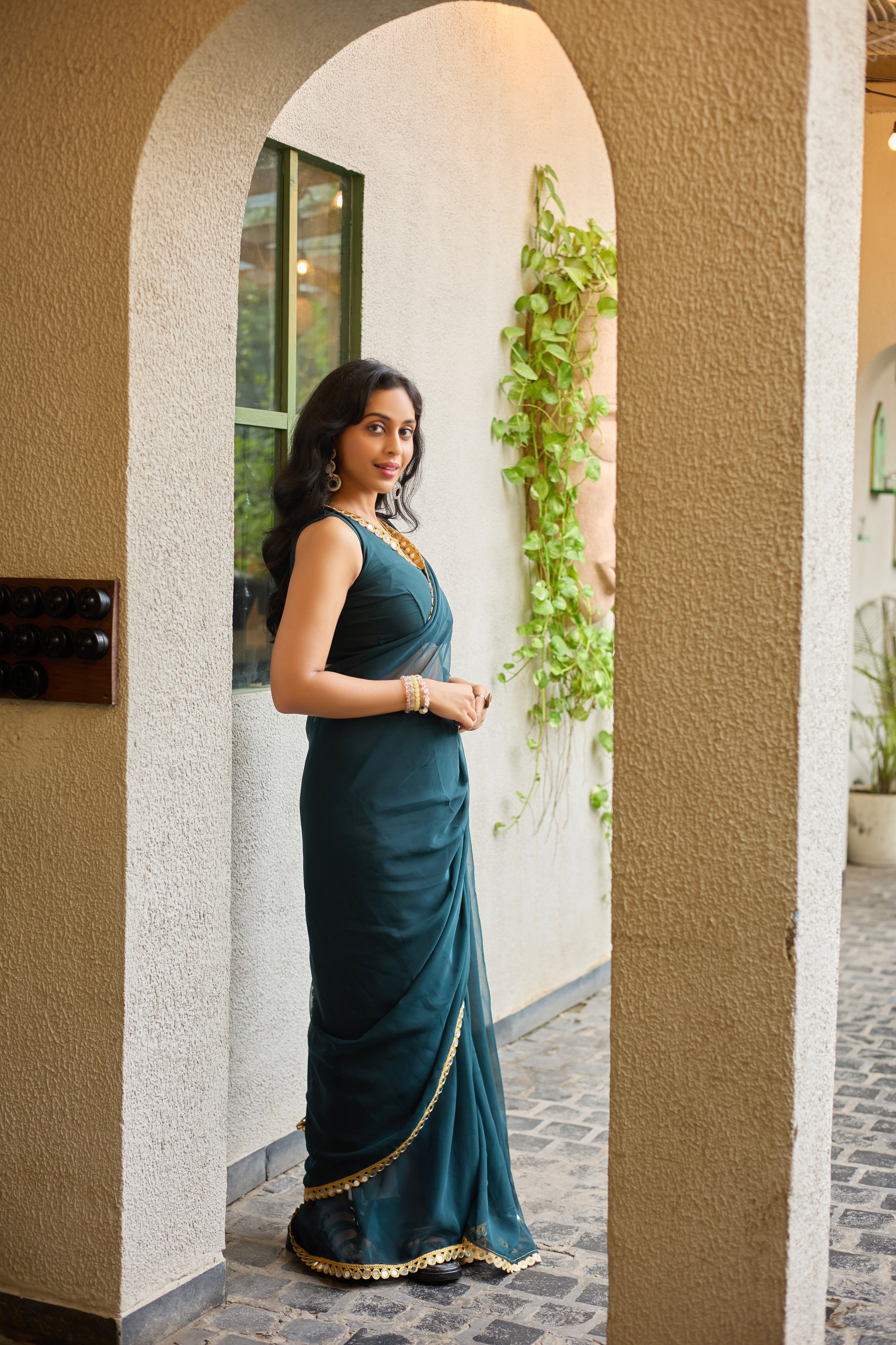 Teal Charm Georgette Saree with Golden Mirror Work Border