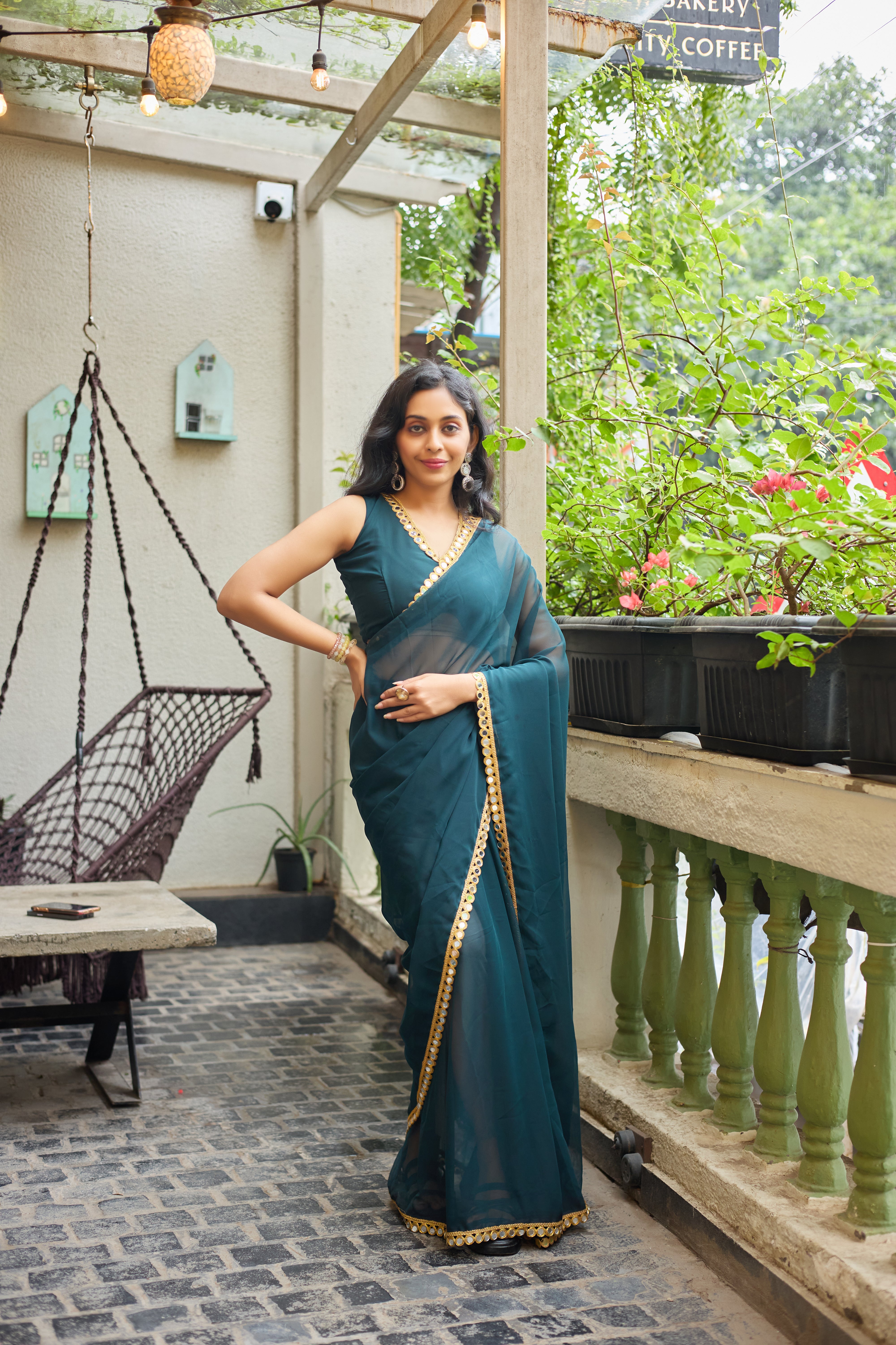 Teal Charm Georgette Saree with Golden Mirror Work Border